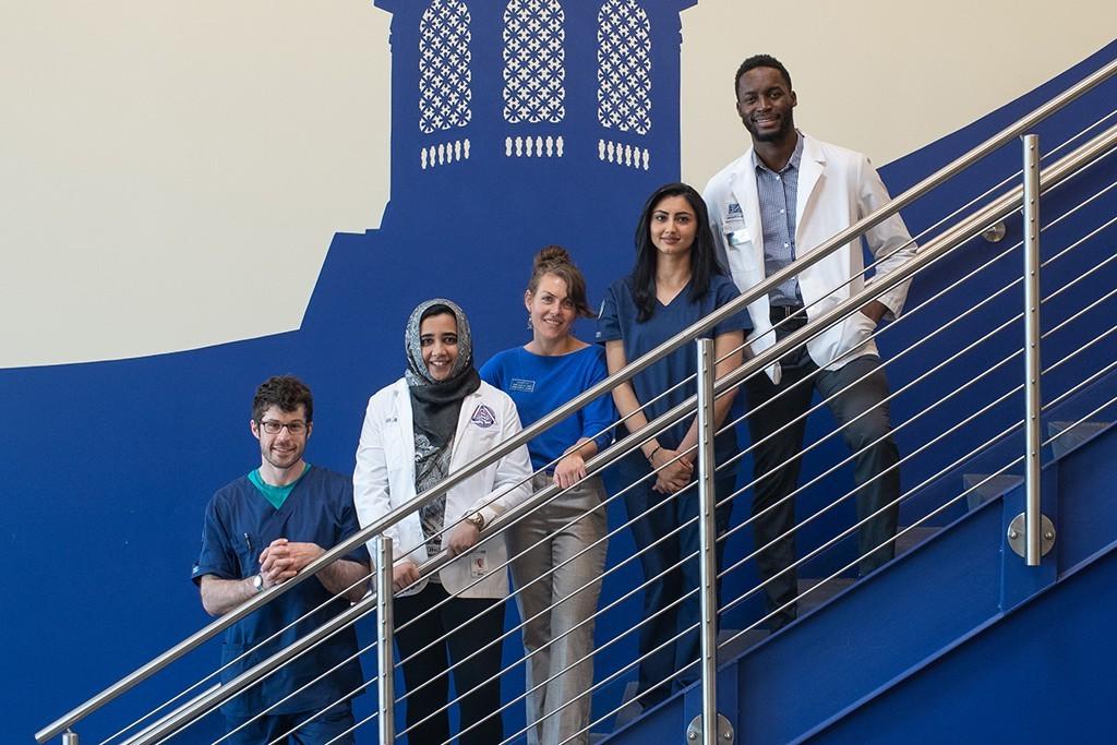 A group of health 学生 standing on the staircase in Innovation Hall