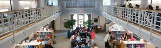 A view from the catwalk in the Portland campus library of 学生 studying in the library