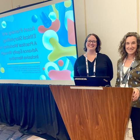 Pamela Bruno (left) and Colleen Fuller from UNE's Center from Excellence in Public 健康 pose for a photo next to a slideshow presentation displayed on a screen